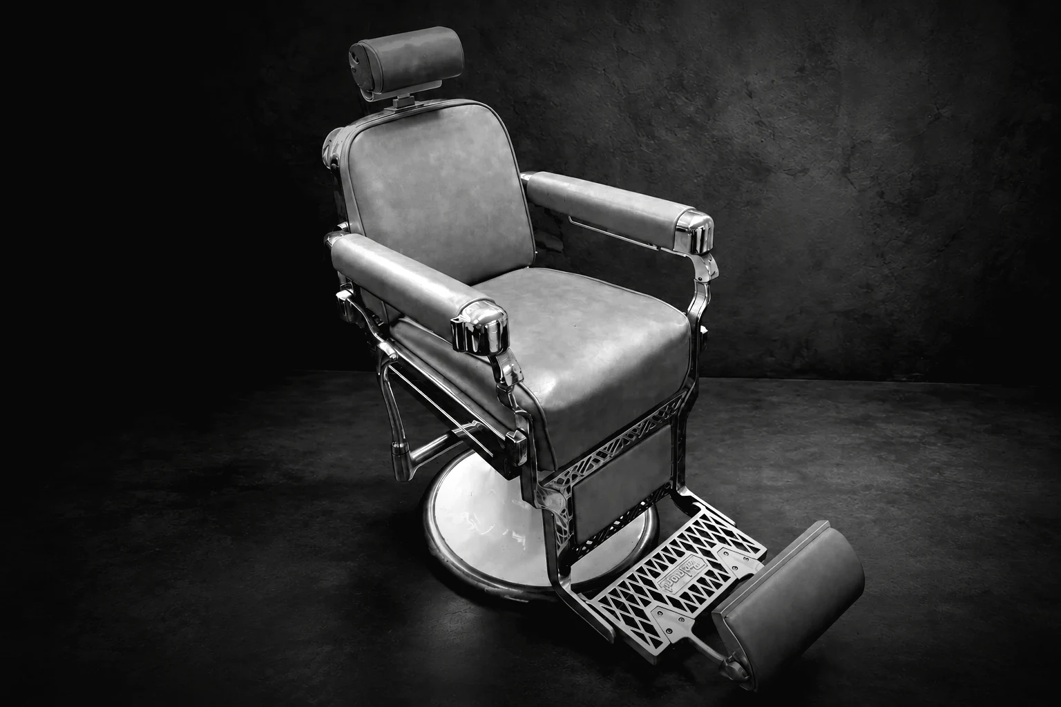 Janet's vintage Belmont barber chair — deep grey upholstery, nickel-plated arms and a cast footrest — standing in her studio.
